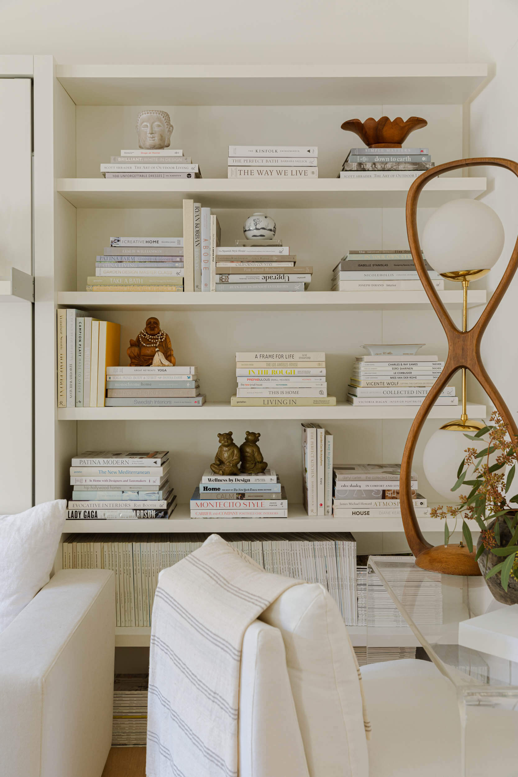 Bookshelf filled with books and decorative items in a living room setting.