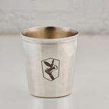 Silver cup with an engraved logo on a light gray background