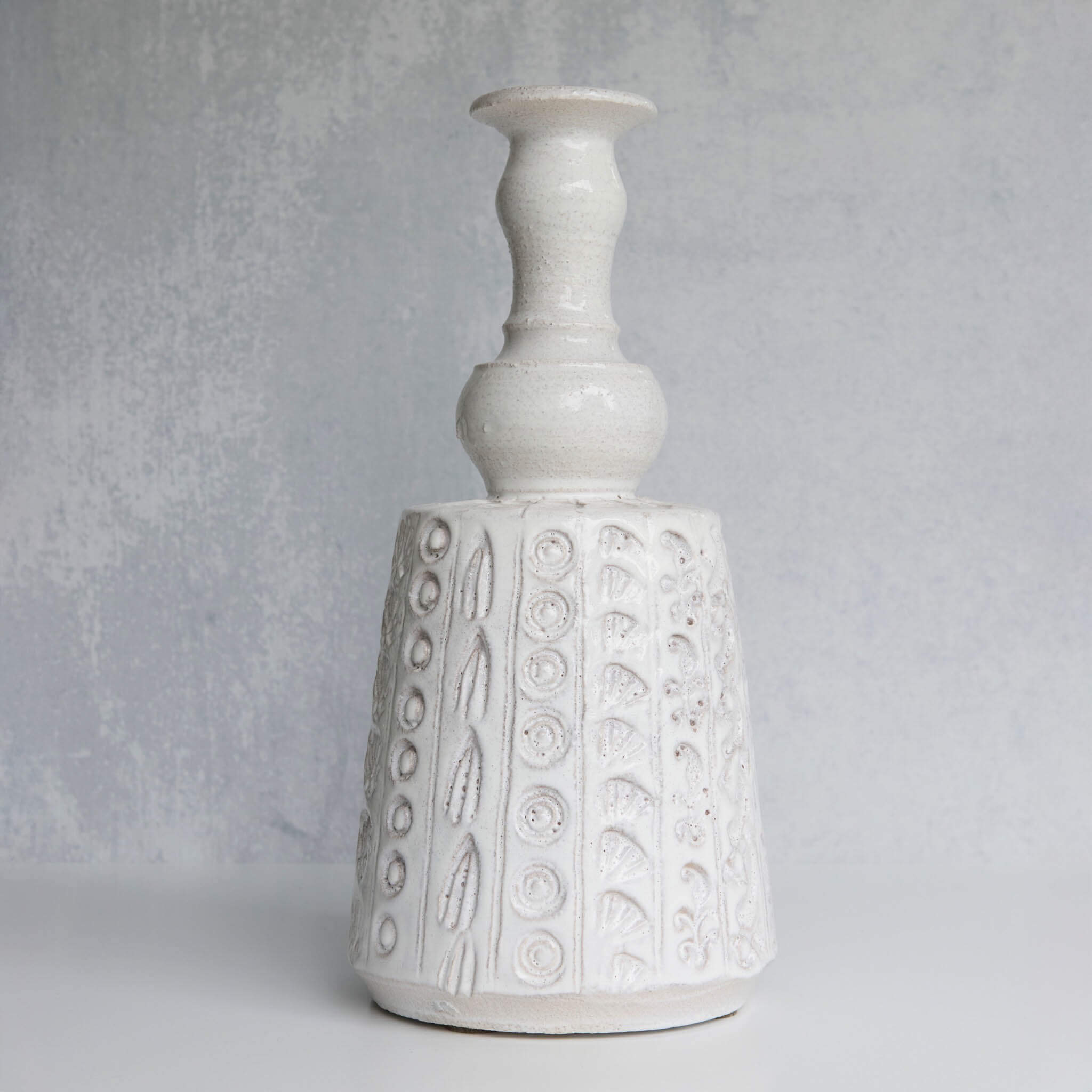 White textured ceramic vase on a light gray background