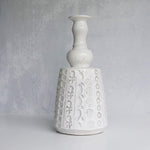 White textured ceramic vase on a gray background