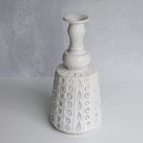 White textured ceramic vase on a gray background