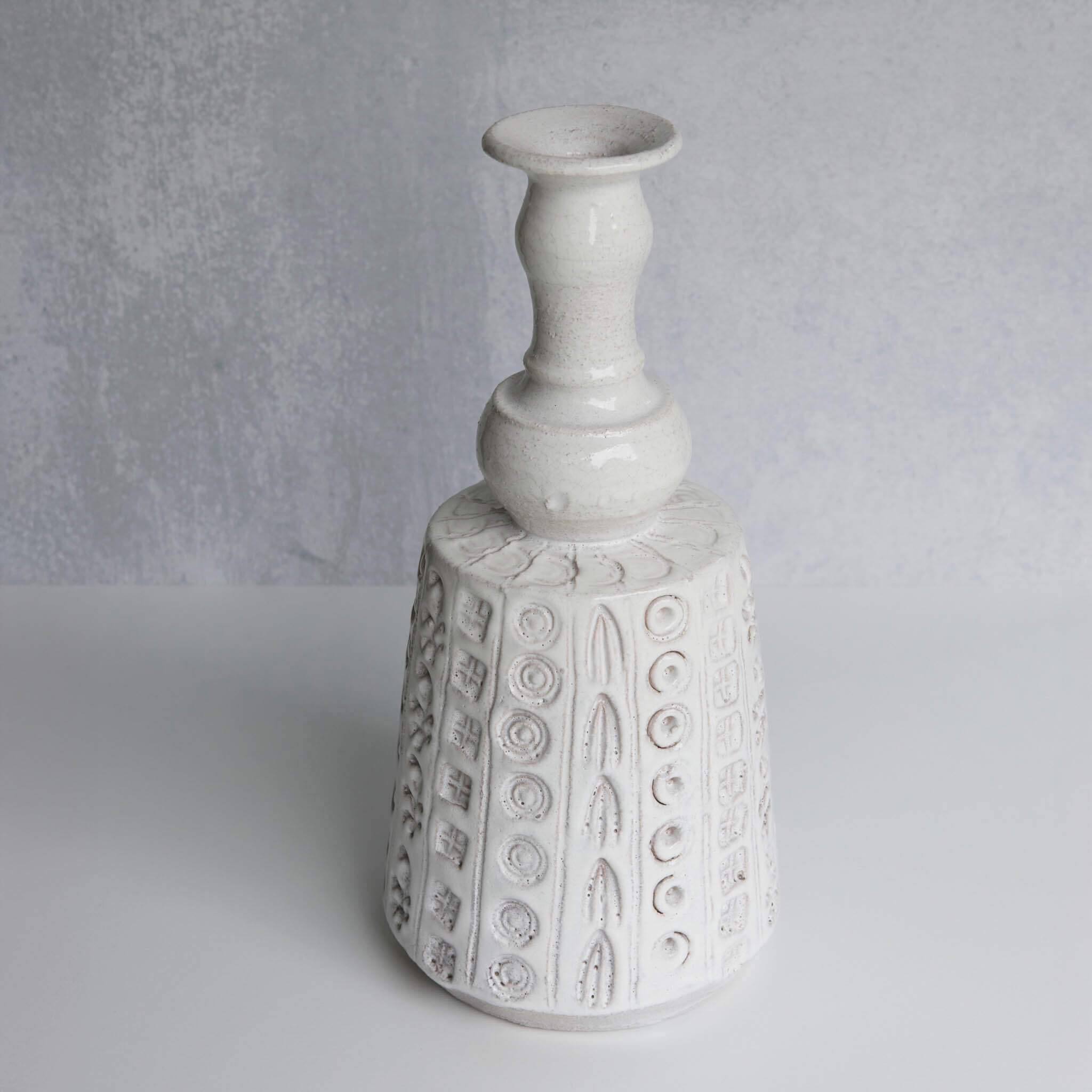 White textured ceramic vase on a gray background