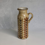 Ceramic Malarmey pitcher with leaf pattern on a gray background