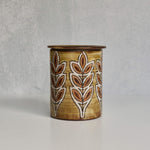 Ceramic Malarmey lidded jar with leaf pattern on a gray background