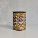 Ceramic Malarmey lidded jar with leaf pattern on a gray background