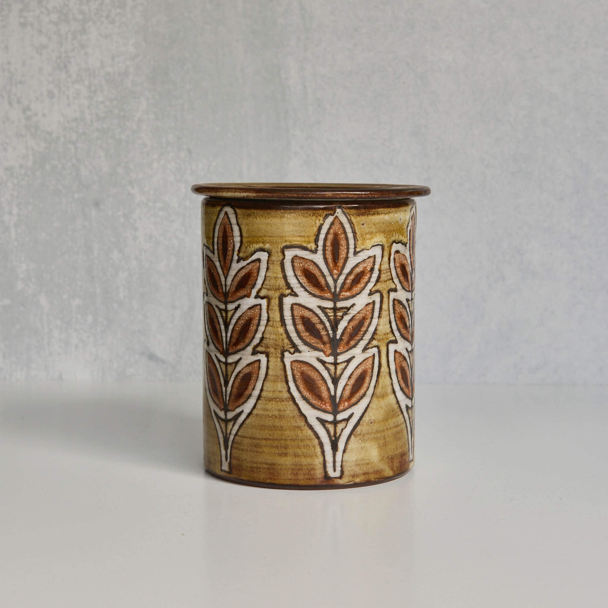 Ceramic Malarmey lidded jar with leaf pattern on a gray background