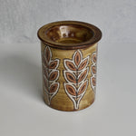Ceramic Malarmey lidded jar with leaf patterns on a gray background