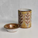 Ceramic Malarmey lidded jar with leaf pattern on a gray background