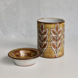 Ceramic Malarmey lidded jar with leaf pattern on a gray background