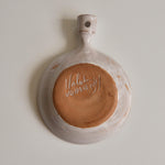The bottom of a ceramic dish with 'Malarmey' signature on a plain background