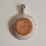 The bottom of a ceramic dish with 'Malarmey' signature on a plain background